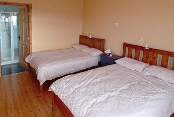 one bedroom ensuite with two double beds downstairs 